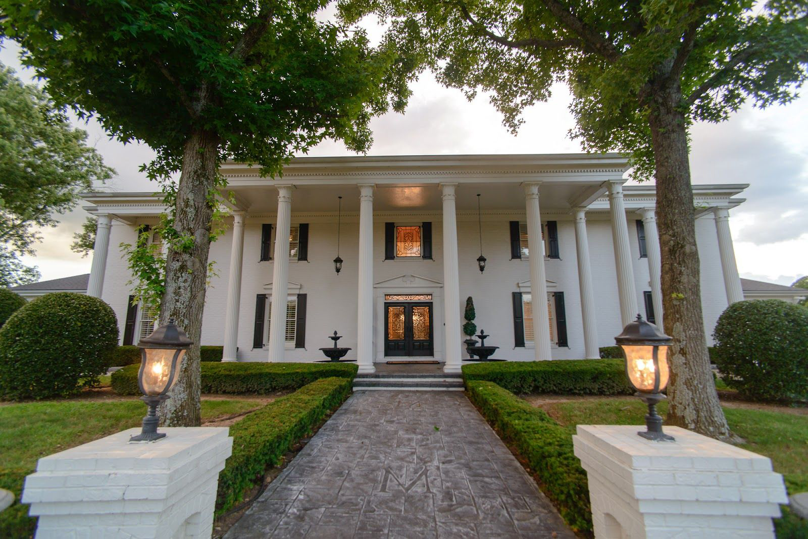 A beautifully prepared home exterior with manicured hedges and a clean walkway, ready for listing photos
